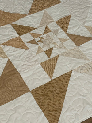 Tan star quilt with light border