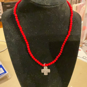 Silver cross on red coral beaded necklace