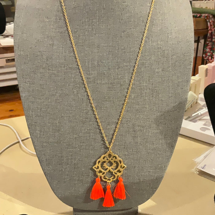 Long, medallion with orange tassel necklace
