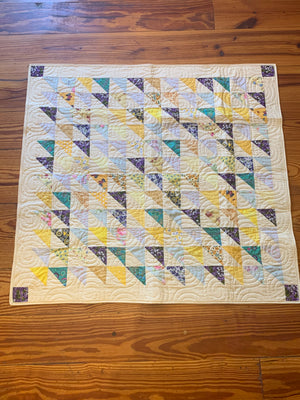 Yellow and purple triangle baby quilt