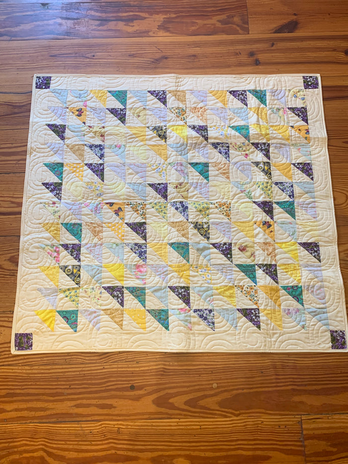 Yellow and purple triangle baby quilt