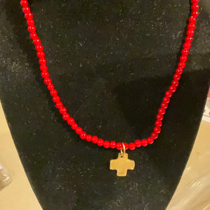 Gold cross on red coral beaded necklace